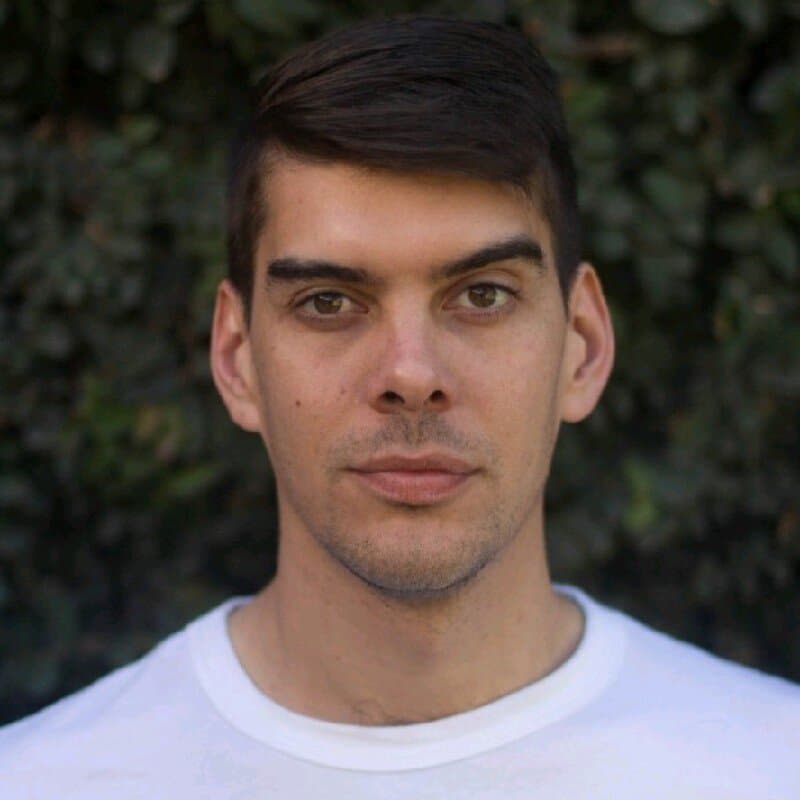 Santiago Vittor, headshot against a green hedge